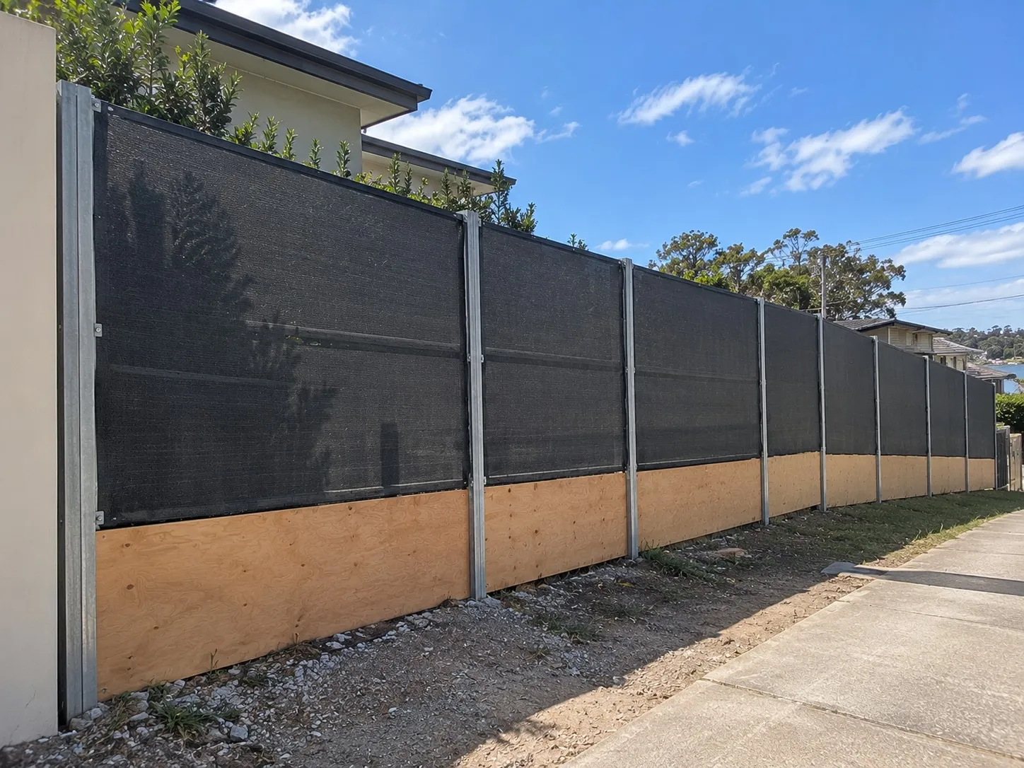 Tall acoustic fence with steel posts built for wind loads in Wellington