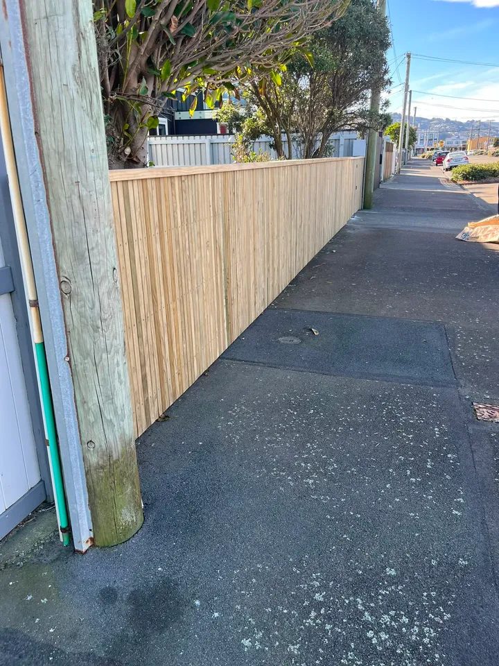 Timber boundary fence beside a Wellington footpath