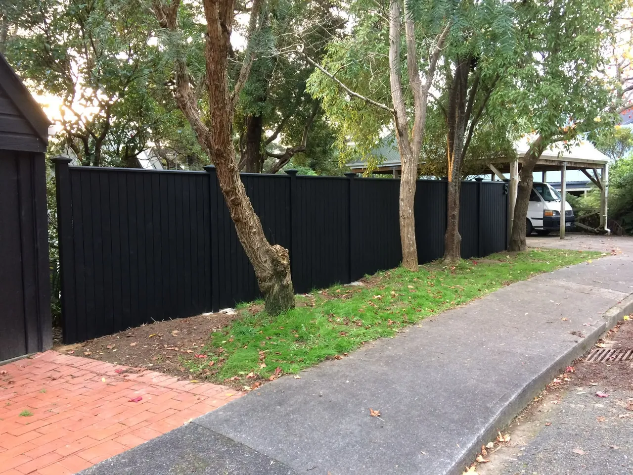 Black slat fence panels lining a Wellington street