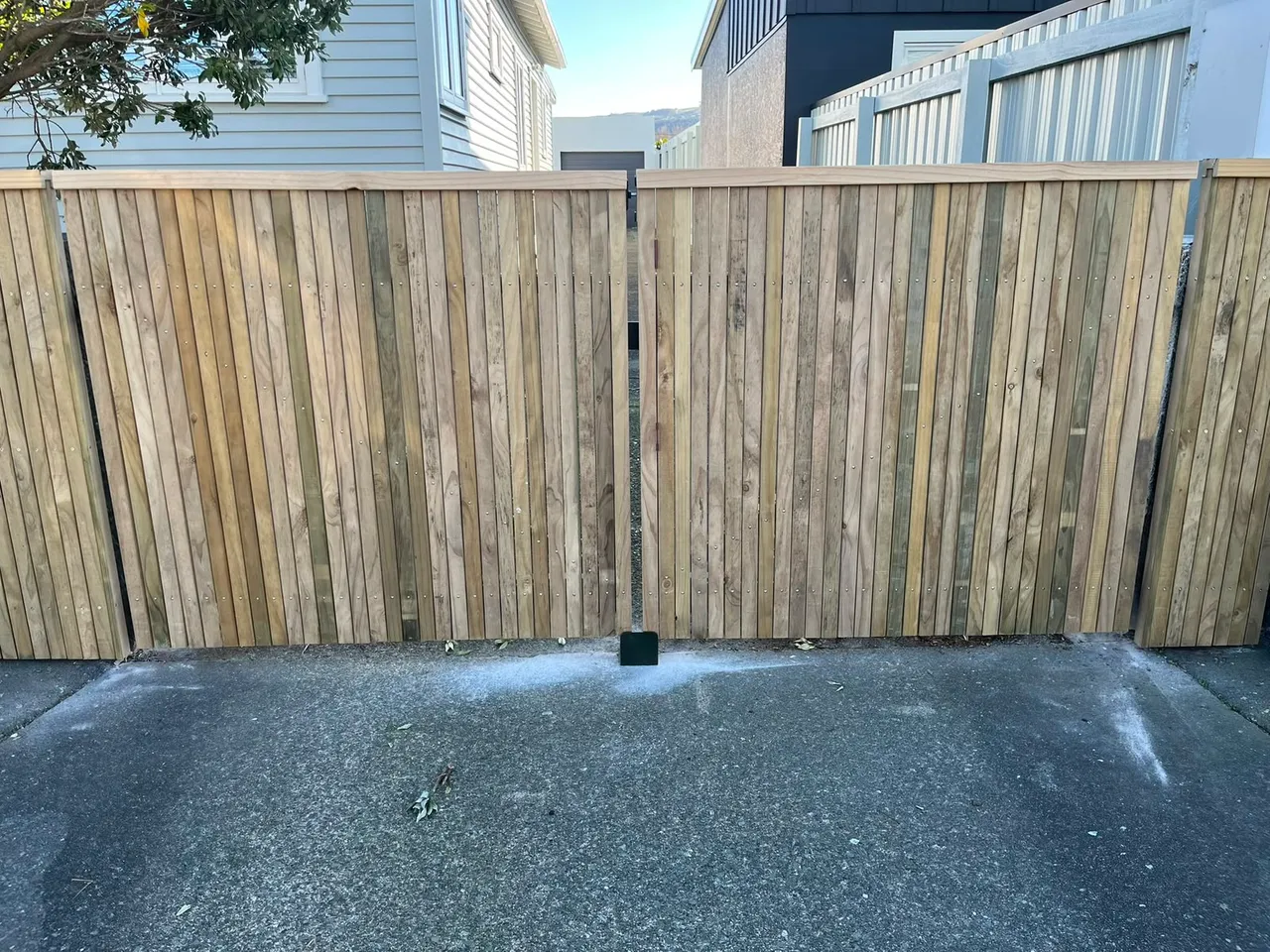 Vertical timber double gate on a Wellington driveway