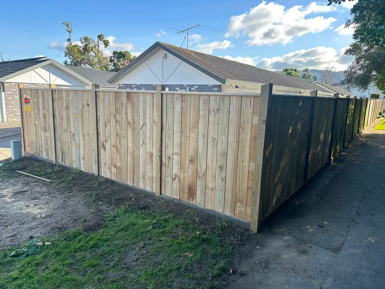 Timber boundary fence around a Wellington yard