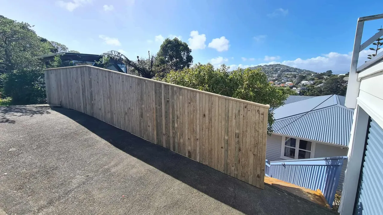 Timber boundary fence on a sloped Wellington driveway